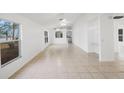 Spacious living room with tile floors and ceiling fans at 8419 Quarter Horse Dr, Riverview, FL 33578