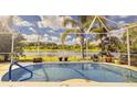 Relaxing pool area with screened enclosure and lake view at 10919 Australian Pine Dr, Riverview, FL 33579