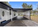 Covered carport with stone and whitewashed walls at 11119 N 21St St, Tampa, FL 33612