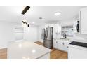 Modern white kitchen with stainless steel appliances and island at 11119 N 21St St, Tampa, FL 33612