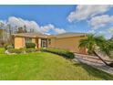 House exterior showcasing the side yard landscaping and a paved walkway at 1123 Emerald Dunes Dr, Sun City Center, FL 33573