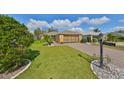 Single story house exterior with landscaped yard and paved driveway at 1123 Emerald Dunes Dr, Sun City Center, FL 33573