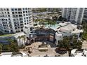 Aerial view of luxury towers with a pool, lush landscaping, and convenient parking at 1209 E Cumberland Ave # 505, Tampa, FL 33602