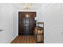 Welcoming entrance featuring a dark wood door, stylish lighting, and a storage shelf at 1209 E Cumberland Ave # 505, Tampa, FL 33602