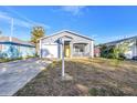 Newly renovated gray house with yellow door, white porch and a fenced yard at 1410 Prescott S St, St Petersburg, FL 33712