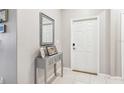 Bright entryway with a console table and a mirror at 14341 Editors Note St, Ruskin, FL 33573