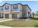 Two-story townhome with stone accents and a metal roof at 14341 Editors Note St, Ruskin, FL 33573