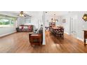 Open concept dining area with a wooden table and chairs, adjacent to the living room at 1720 Hampton Ln, Clearwater, FL 33756