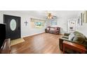 Living room with hardwood floors, comfy couches, and a large window at 1720 Hampton Ln, Clearwater, FL 33756