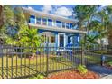 Renovated blue house with a white trim, black fence, and manicured lawn at 2751 2Nd S Ave, St Petersburg, FL 33712