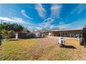 Large backyard with a covered patio and various outbuildings at 2809 49Th N St, St Petersburg, FL 33710