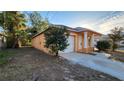 View of the house's side elevation, showing garage and landscaping at 3101 E 23Rd Ave, Tampa, FL 33605