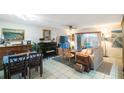 Spacious living area with dining area and piano at 3710 41St S Way # C, St Petersburg, FL 33711