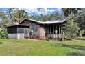 Rustic wood home with metal roof and screened porch at 4001 Keene Rd, Plant City, FL 33565