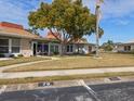 Community view showing multiple mid-century homes and landscaping at 4316 Tahitian Gardens Cir # H, Holiday, FL 34691