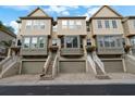 Three-story townhouses with neutral siding and attached garages at 4334 Spinnaker Cove Ln, Tampa, FL 33615