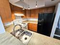 Well-equipped kitchen with modern appliances and wood cabinets at 4405 W Fair Oaks Ave # 10, Tampa, FL 33611