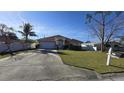 Front yard view of a single-story house with a driveway and landscaping at 6190 107Th N Ave, Pinellas Park, FL 33782