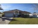 Single-story house with a red tile roof, attached garage, and well-maintained lawn at 6190 107Th N Ave, Pinellas Park, FL 33782