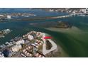 Aerial view of waterfront home and community, showing location on a peninsula at 887 S Gulfview Blvd, Clearwater Beach, FL 33767