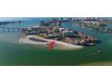 Wide aerial view of waterfront property with a home on a small island at 887 S Gulfview Blvd, Clearwater Beach, FL 33767