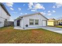 Brightly lit house with a side yard and attached garage at 10323 Del Mar Cir, Tampa, FL 33624