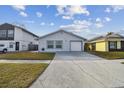 Newly remodeled home with a driveway and landscaped front yard at 10323 Del Mar Cir, Tampa, FL 33624