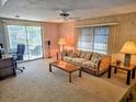 Living room with sofa, coffee table, and carpet flooring at 12501 Ulmerton Rd # 188, Largo, FL 33774