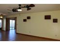 Spacious living room features tile floors, ceiling fans, and access to other living spaces at 1322 Kenmore St, Port Charlotte, FL 33952