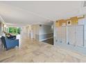 Condo building lobby with seating, mailboxes, and tile floors at 134 Mariner Dr # 134, Tarpon Springs, FL 34689