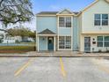 Front view of a two-story townhome with a blue and yellow exterior at 13817 Stone Mill Way, Tampa, FL 33613