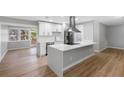 Modern kitchen with stainless steel appliances and breakfast bar at 1399 Grapeleaf Ct, Tarpon Springs, FL 34689