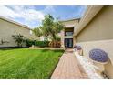 House exterior showcasing walkway, landscaping, and a lush lawn at 1553 Regal Mist Loop, Trinity, FL 34655