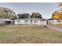 Front view of a charming ranch style home with a fenced yard at 1806 E Alabama St, Plant City, FL 33563
