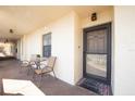 Inviting condo entrance featuring a cozy seating area and a well-lit doorway with a 'Welcome' mat at 19029 Us Highway 19 N # 26-206, Clearwater, FL 33764