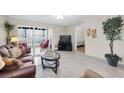Open-concept living room with view to bedroom, comfortable seating, and plenty of natural light at 19029 Us Highway 19 N # 26-206, Clearwater, FL 33764