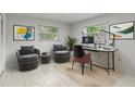 Bright home office with two armchairs and a modern desk at 1903 Oro Ct, Clearwater, FL 33764