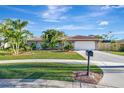 House with tile roof, palm trees, and a well-manicured lawn at 2851 Hardee Dr, Sarasota, FL 34231