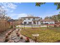 Beautiful backyard featuring a fence, artificial turf, and a serene lounging area at 403 Weeburn Rd, Temple Terrace, FL 33617