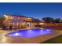 Back of house view featuring a beautiful pool, patio area, a balcony and a well-kept backyard at 403 Weeburn Rd, Temple Terrace, FL 33617