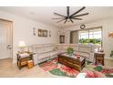 Inviting living room featuring neutral tones, a ceiling fan, and a sliding glass door leading to the lanai at 4748 Ballast Crest Cv, Land O Lakes, FL 34638