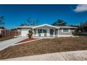 Charming single-story home with a well-maintained lawn and inviting front porch seating at 5405 Golden Nugget Dr, Holiday, FL 34690