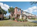 Two-story townhome with attached garage and landscaping at 7069 Towne Lake Rd, Riverview, FL 33578