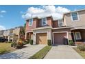 Two-story townhome with attached garage and landscaping at 7069 Towne Lake Rd, Riverview, FL 33578