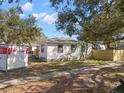 Side view of a bright single-story home featuring neat landscaping at 738 59Th Ne Ave, St Petersburg, FL 33703