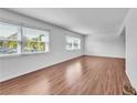 Bright living space with hardwood floors and large windows offering ample natural light at 1137 King Arthur Ct # 510, Dunedin, FL 34698