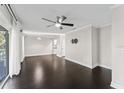 Spacious living room, dark hardwood floors, and ceiling fan at 13682 Orange Sunset Dr # 201, Tampa, FL 33618