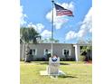 Community clubhouse showcases an American flag and landscaping, fostering neighborhood pride at 145 Blue Marlin Dr, Oldsmar, FL 34677