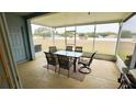 Screened patio with table and chairs, overlooking a backyard at 1552 Blue Magnolia Rd, Brandon, FL 33510