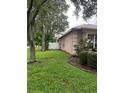 Side view showing well-maintained yard and white fence at 18108 Sugar Brooke Dr, Tampa, FL 33647
